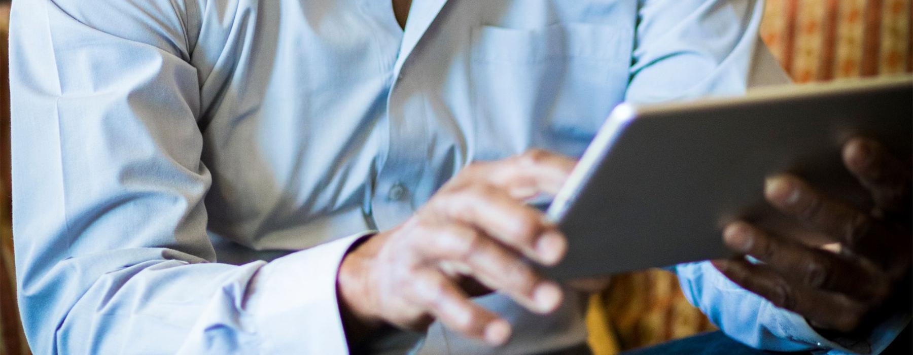 a man holding a tablet