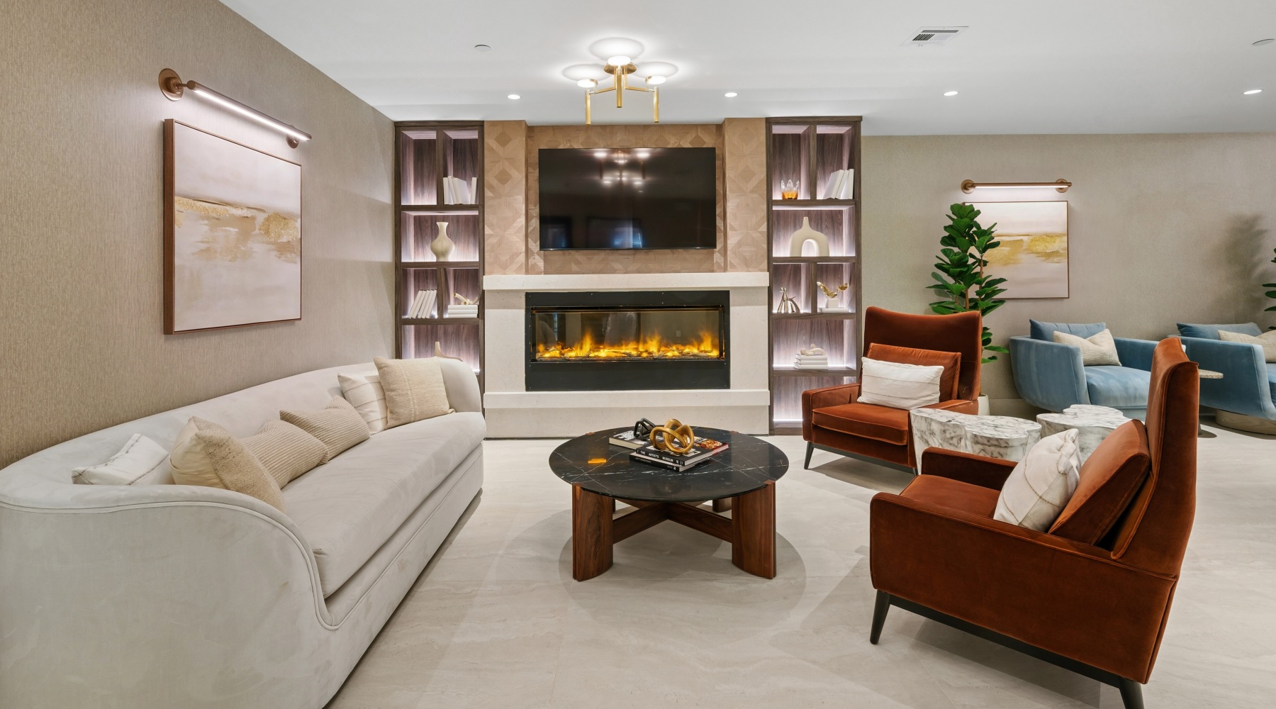Clubroom with sofa, chairs, and electric fireplace.